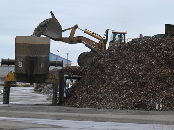 A front loader loads scrap metal