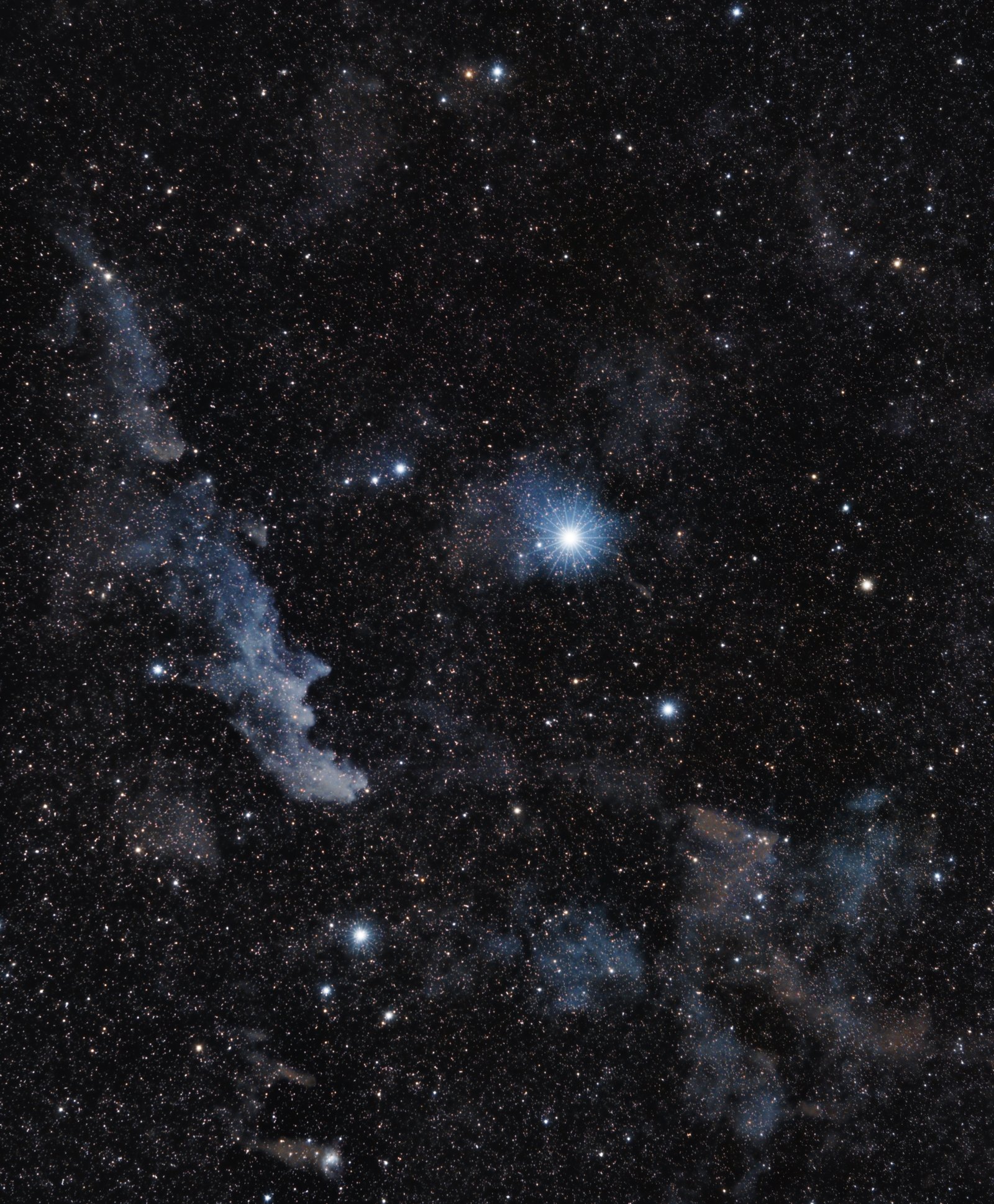 The Pleiades star cluster, also known as the Seven Sisters, showing bright blue stars surrounded by nebulous gas and dust.